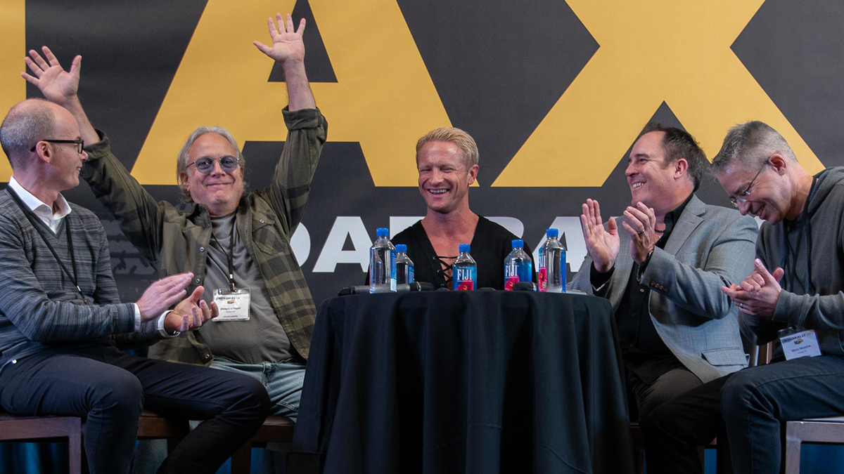 Music Supervisor Mason Cooper raises his hands in victory after making a funny comment on the, 